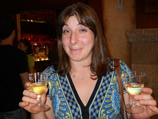 a woman holding wine glasses