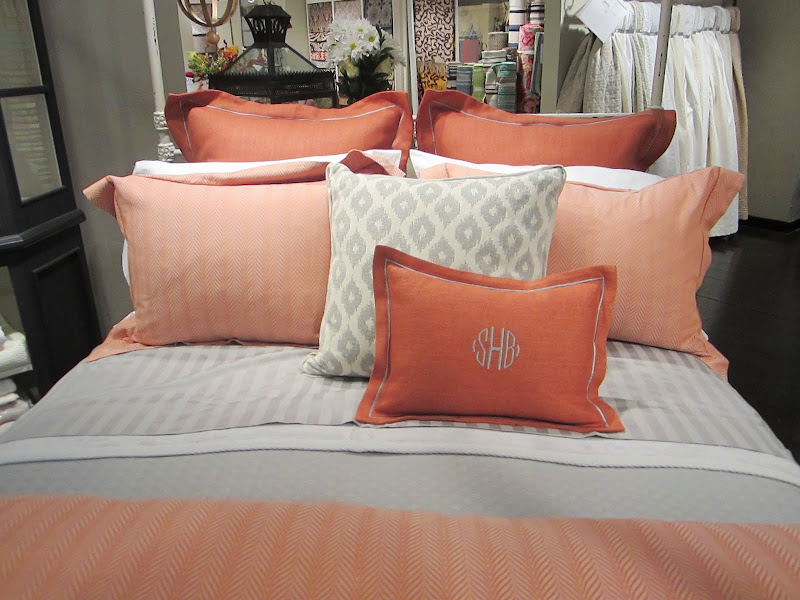 Close up of the elegant coral and grey pillows from Peacock Alley