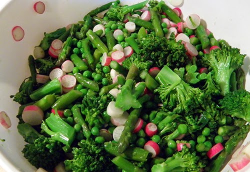 Colander of broccolini, peas, asparagus, and peas