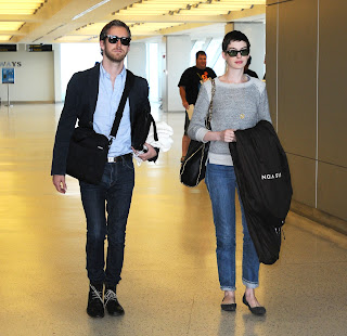 Anne Hathaway carrying a dress