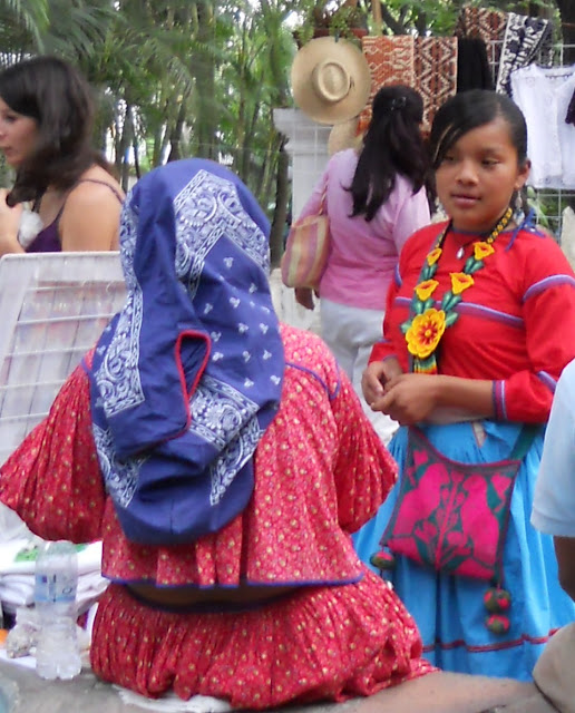 young girl wearing a colourful handmade beaded necklace with large yellow flowers