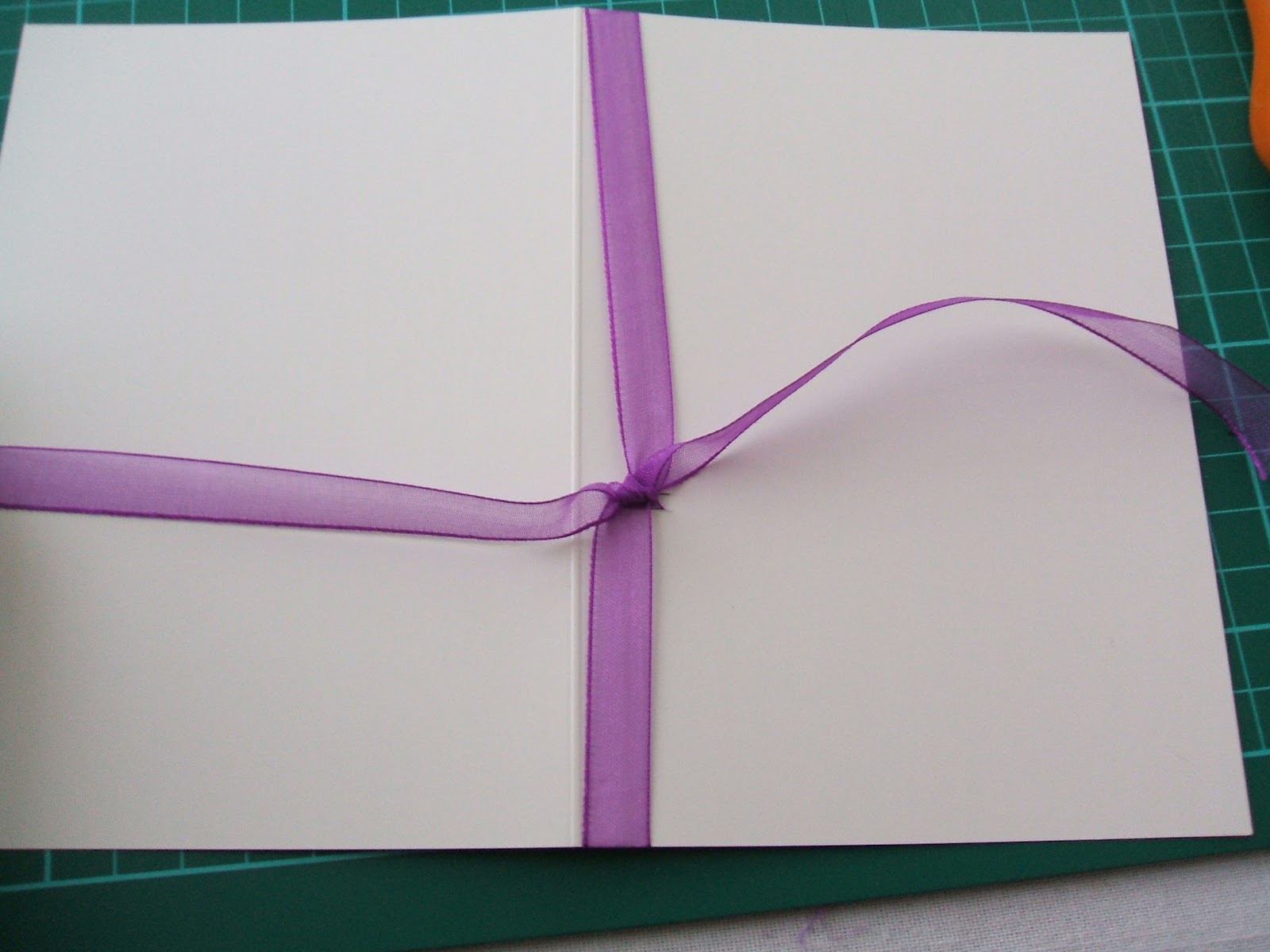 say it says How to tie a ribbon round a card