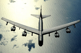 A B-52 Stratofortress flies high above the sea in the pacific.