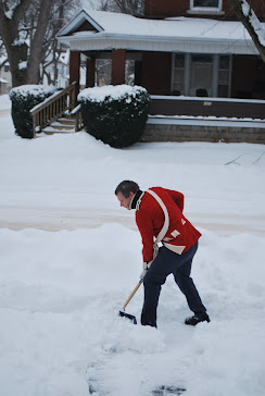 A redcoat removing snow.