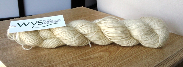 a skein of undyed wool, creamish in colour. 