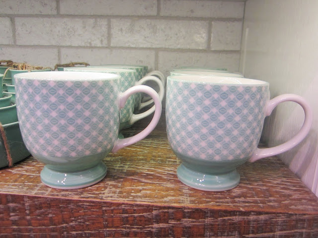 Two rows of blue and white modernist mugs