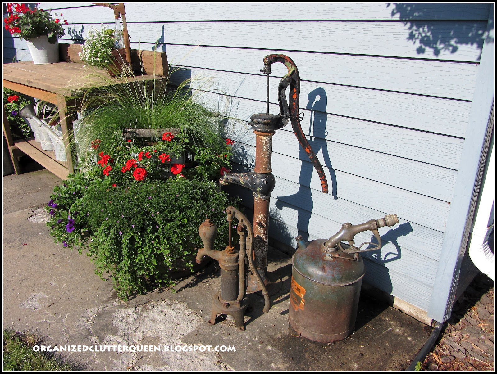 Potting Bench, Whiskey Barrels, and Hanging Pails Organized Clutter