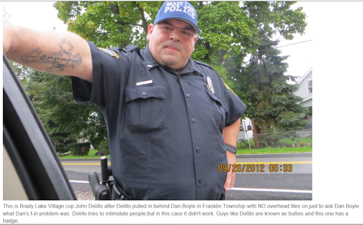 Brady Lake Village cop John Delillo has real problems with his  picture being taken !