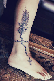 An interesting anklet tattoo with feather and cross as pendant.