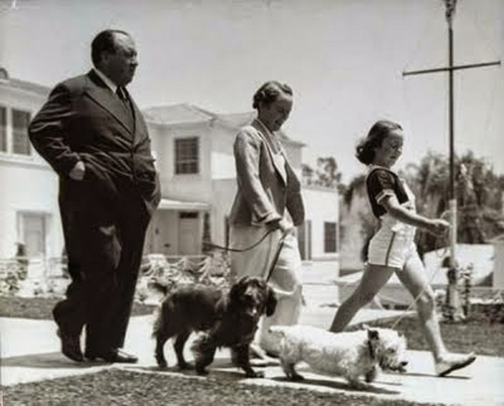 Alfred Hitchcock wife Alma and daughter Pat walking the dogs in 1939.