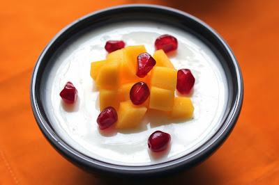 Greek yogurt panna cotta with diced mango and pomegranate seeds