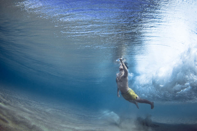 Fotos submersas de banhistas passando debaixo de ondas