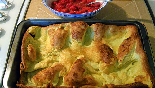 Pan of Baked Popover Pancake with Strawberries on Side