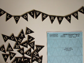 Black and white miniature bunting, spelling out the word 'blogiversary'