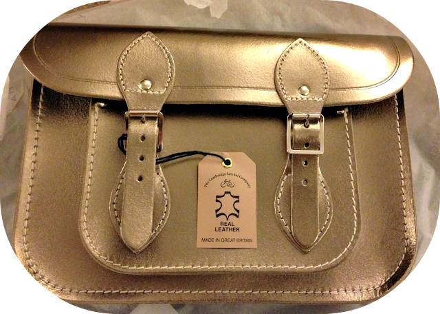 A picture of the outside of a Camrbidge satchel company satchel showing the pockets and the leather with the label and tag still attached