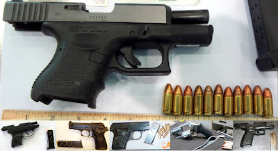 Loaded guns discovered in carry-on bags.