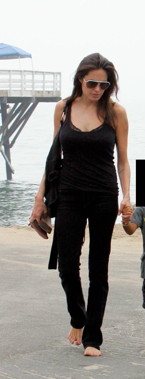 Angelina Jolie barefoot with dirty soles.