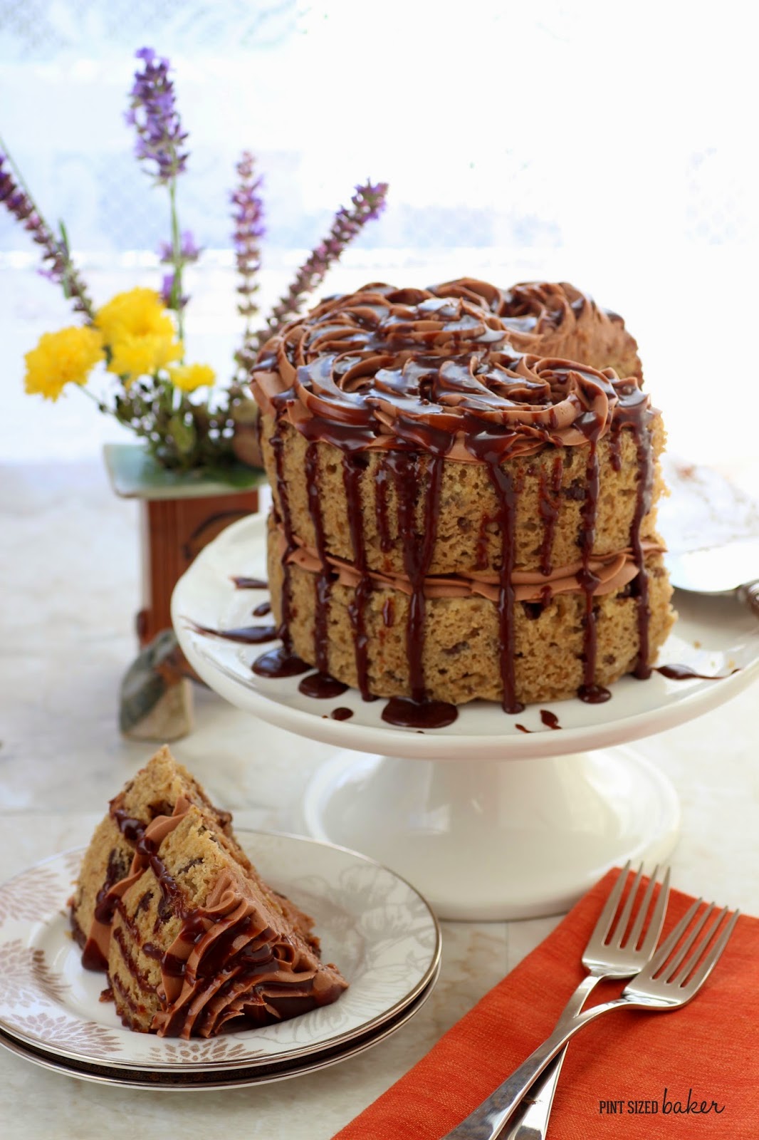 Bake this banana cake in two 6-inch cakes or one 9-inch cake, cover it in chocolate frosting and then drizzle it with melted chocolate hazelnut sauce.