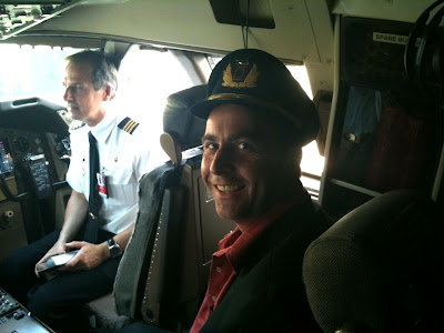 a man in a hat sitting in a plane