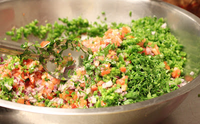 Cilantro, Tomatoes, Onions and lime juice in a mixing bowl