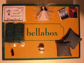 Selection of dolls house miniatures displayed on the top of a small cardboard box labelled 'bellabox'
