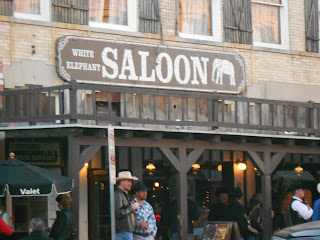 a group of people outside a saloon