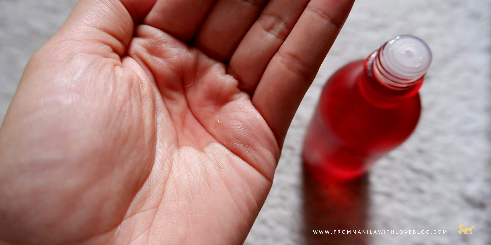 slightly pink/red toner colour an image of a hand with toner liquid in the palm