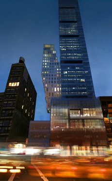 Photo of building at night as seen from the street looking up