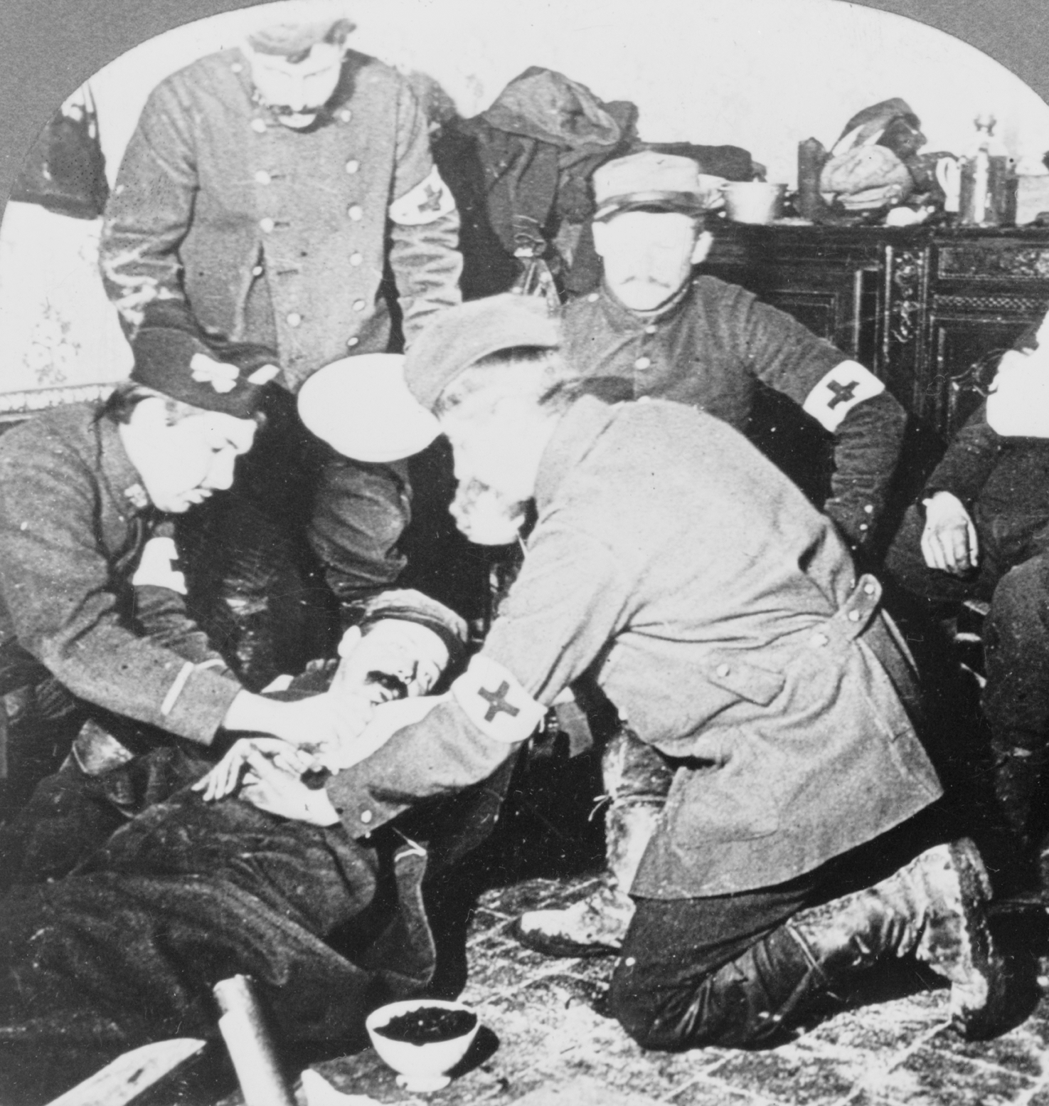A wounded soldier being treated at a field hospital near the front line