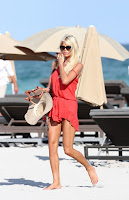 Victoria Silvstedt wearing an orange mini dress and over sized sunglasses