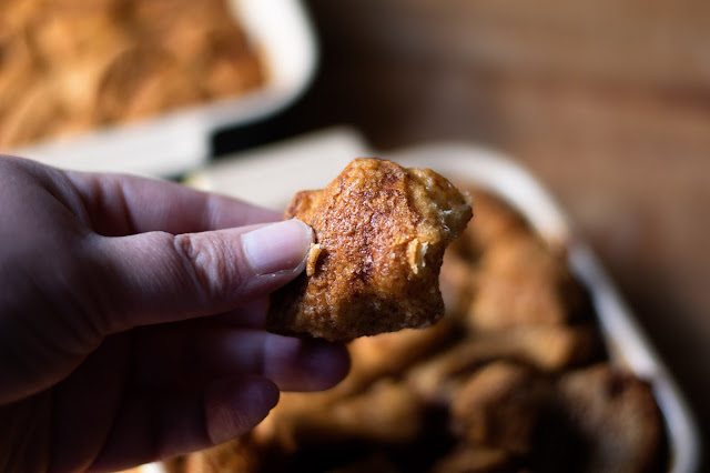 A piece of monkey bread about to be eaten.