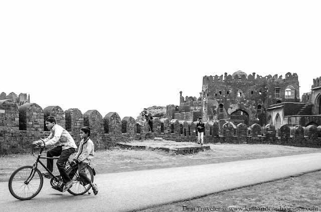 boy riding cycle inside the Bidar Fort