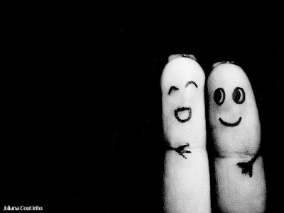 Fingers with faces and arms drawn on them to look like they're hugging.