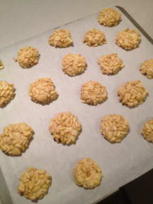 Pignoli cookies on parchment paper, ready to go in the oven