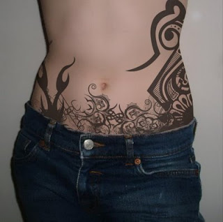 Artistic tribal tattoo design on abdomen and sidebody