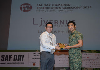 Paulson from LJ Vernus receiving plaque from Minister for Social and Family Development