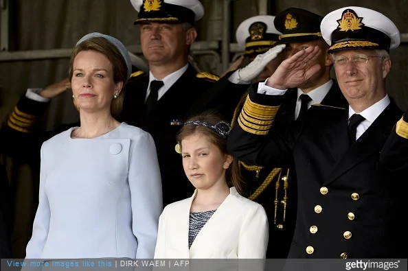 King Philippe of Belgium salutes next to his daughter Princess Elisabeth, Duchess of Brabant, and Queen Mathilde of Belgium during the ship launching ceremony of the P902 Pollux ship with the Duchess of Brabant as official godmother, at the Zeebrugge naval base, on May 6, 2015.