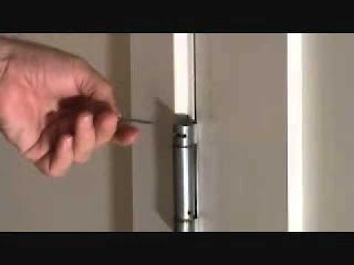 Picture of someone adjusting door hinge strength using an allen key