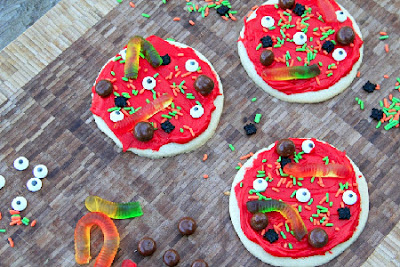 creepy cookie pizzas on a table