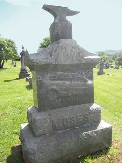 Large gravestone with an anvil carved at the top