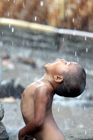 Kid in the Rain. Lombok island.