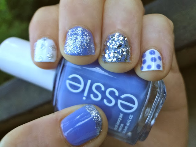 Blue nail polish with silver glitter, white polish with polka dots