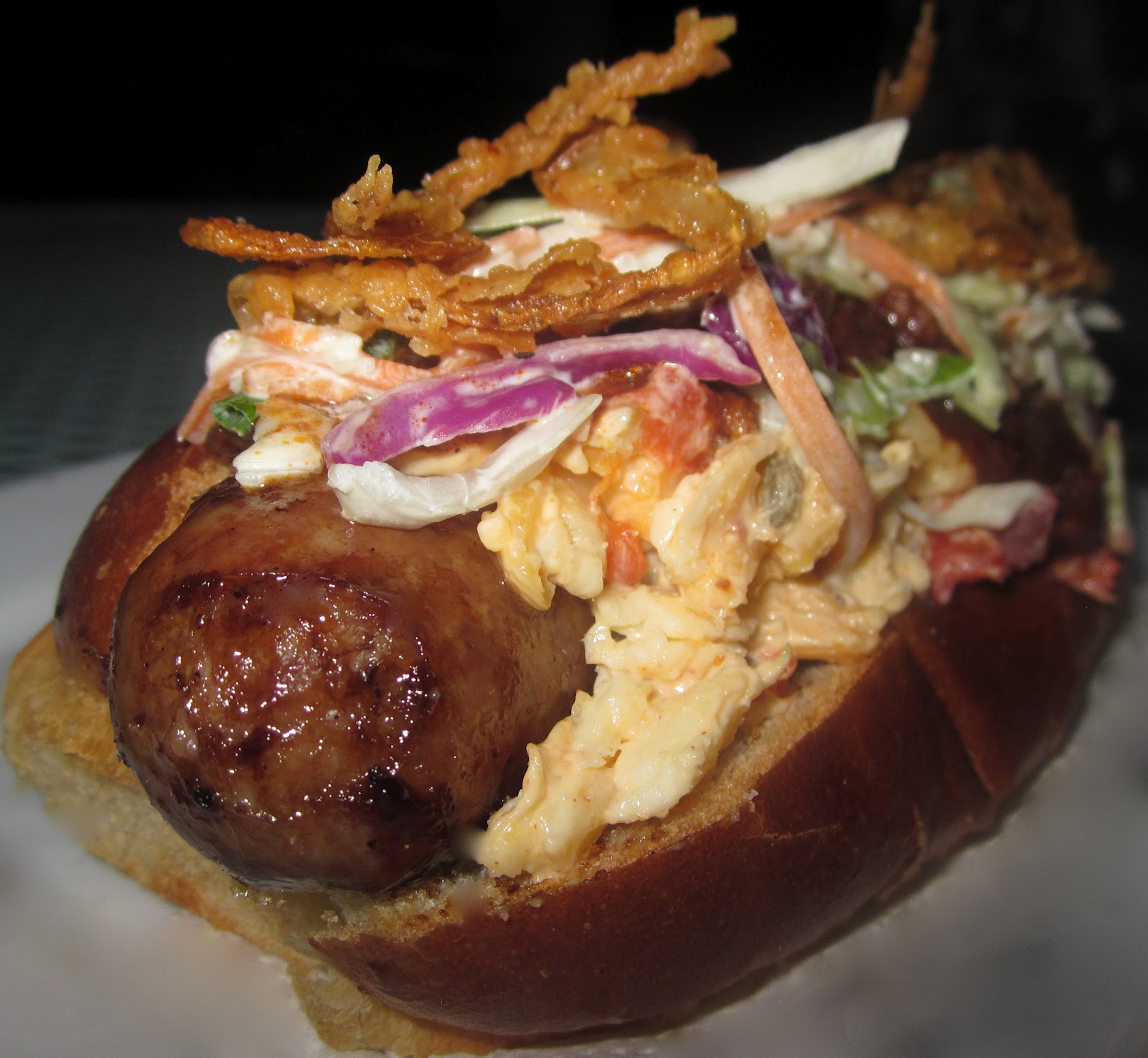 Haute + Heirloom ChiliCheeseSlaw Dogs with Beer Braised Brats topped