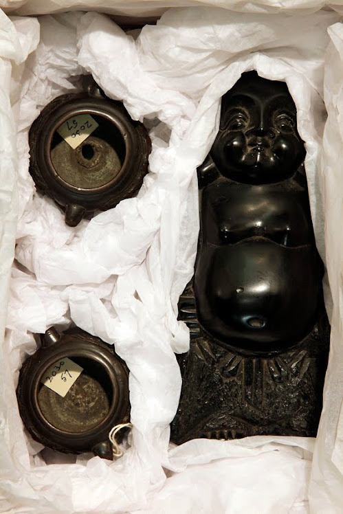Coal Buddha and two miniature bronze urns