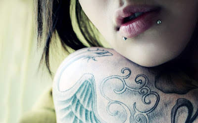 girls wings and tribal tattos in arms