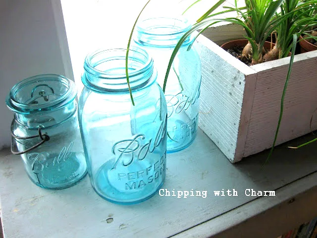 mason jars illuminated in a window
