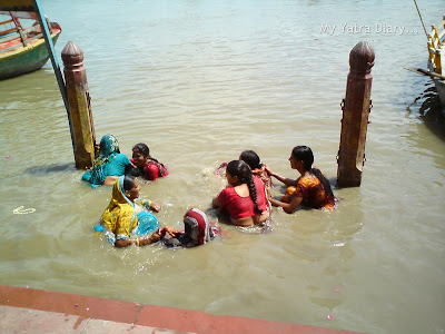 Devotees taking a dip at the Yamuna River Ghat, Mathura