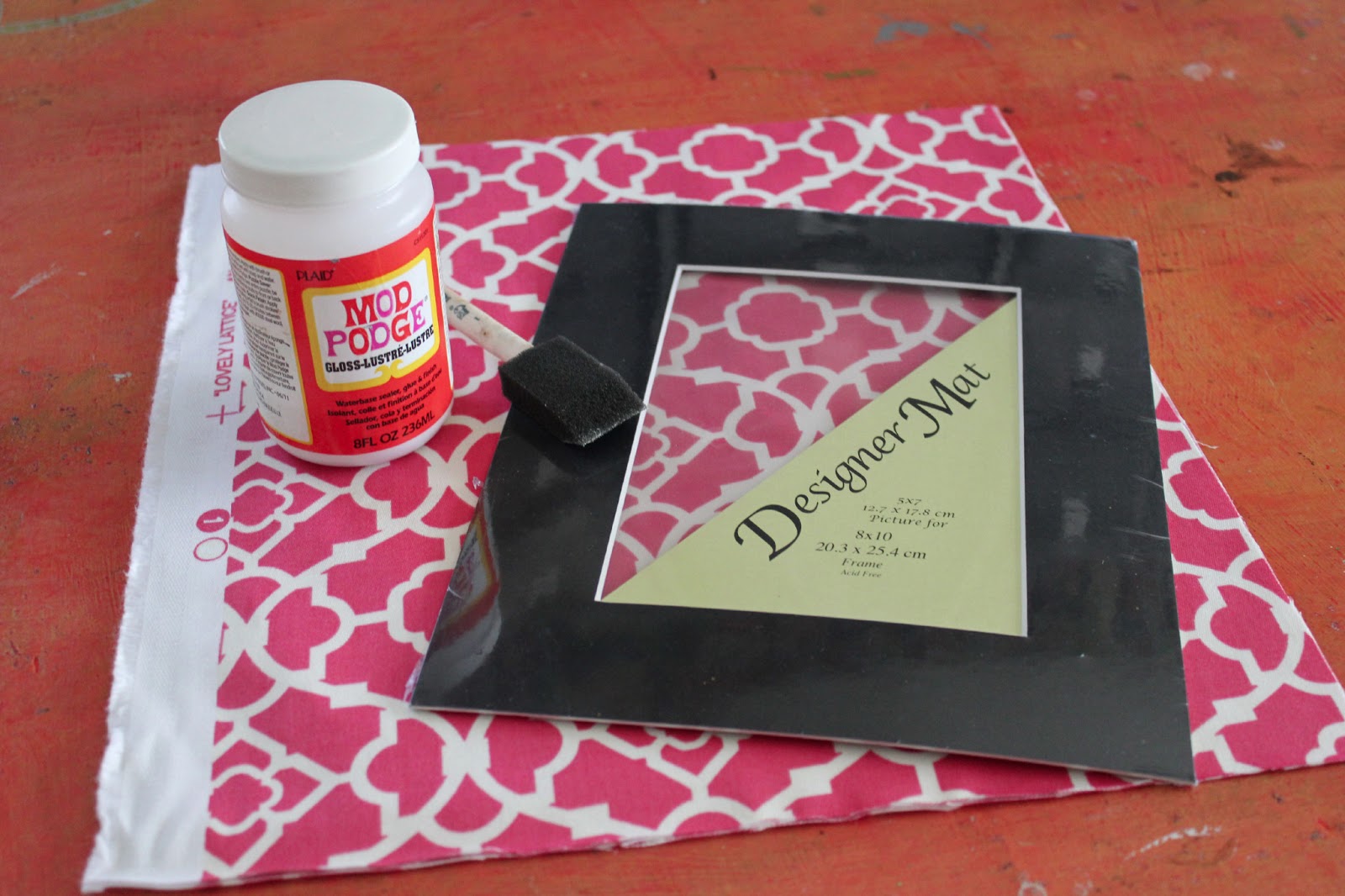 Cathie Filian DIY How to cover a photo mat with fabric and Mod Podge.