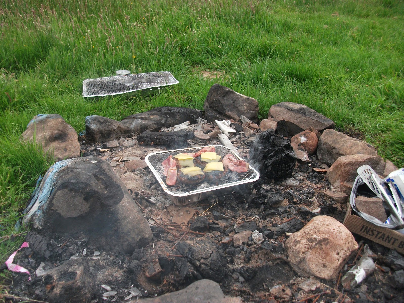Grub cooking on a well used fire pit Grub cooking on a well used fire pit