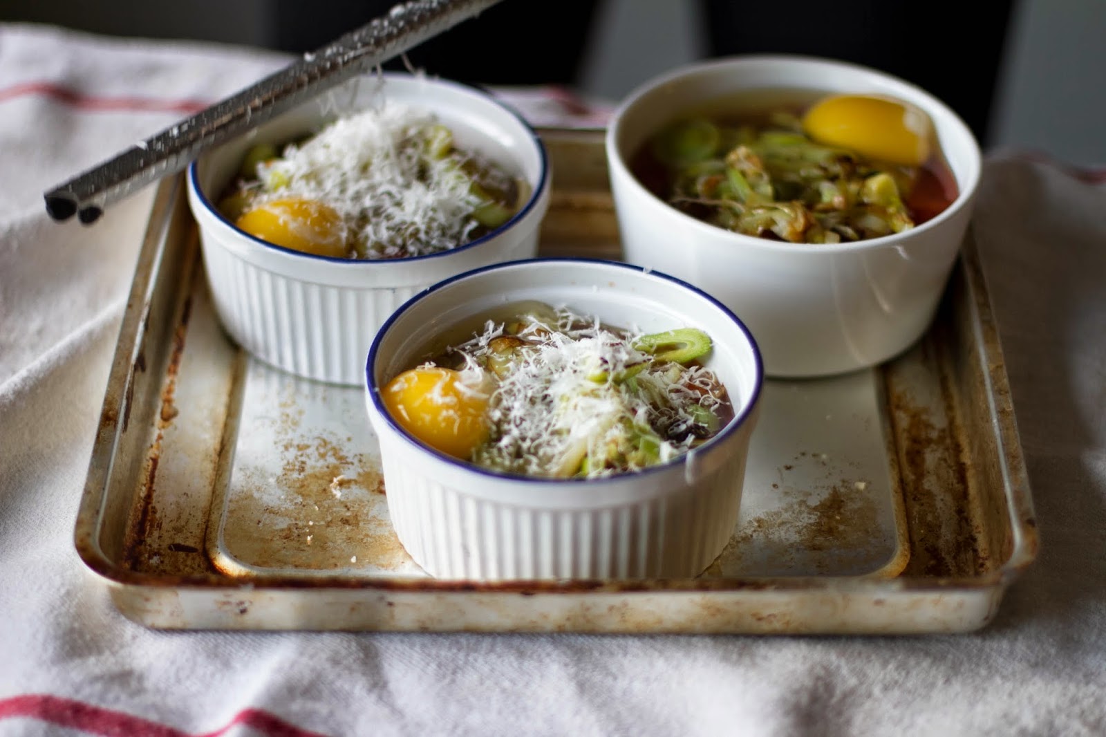 Buttered Up Baked Eggs in Stewed Tomatoes with Caramelized Leeks